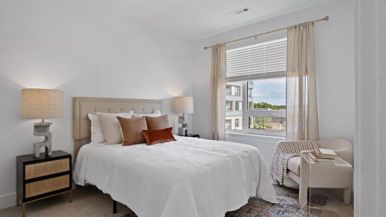 Bedroom with large window, bed and headboard