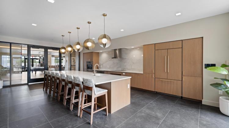 Kitchen with wood cabinets and large island with counters