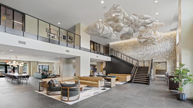 Building lobby with couches and a large staircase