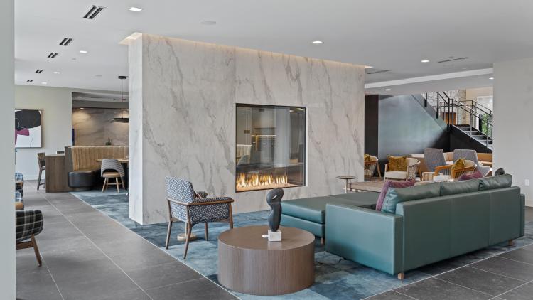 Building lobby with couch seating around fireplace
