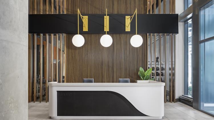 Lobby desk with 3 pendant lights hanging overhead