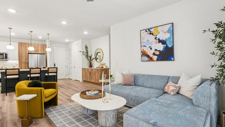 Living room with blue couch and white table