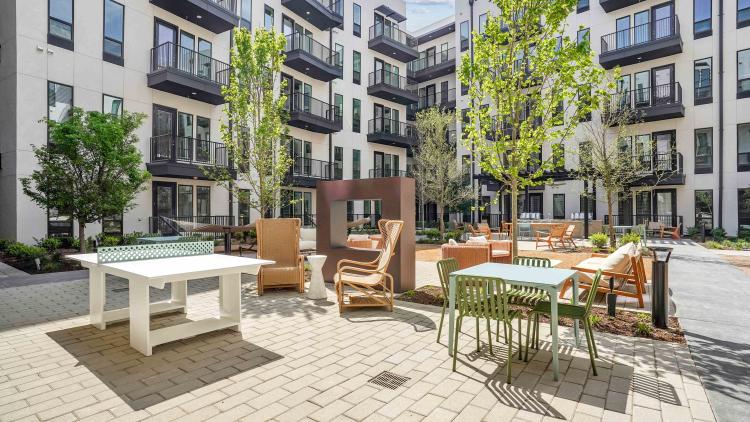 Outdoor courtyard with chairs and ping pong table