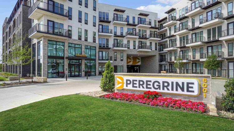 Exterior shot of apartment building with sign outside reading Peregrine