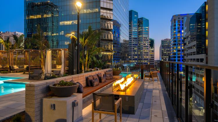 Firepit next to a pool and surrounded by other tall buildings