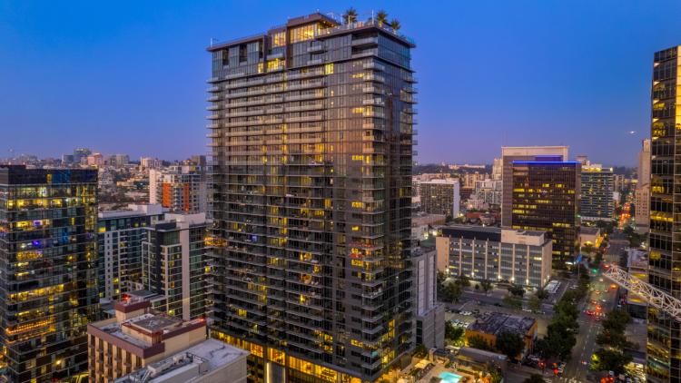 Tall building against a darkening sky