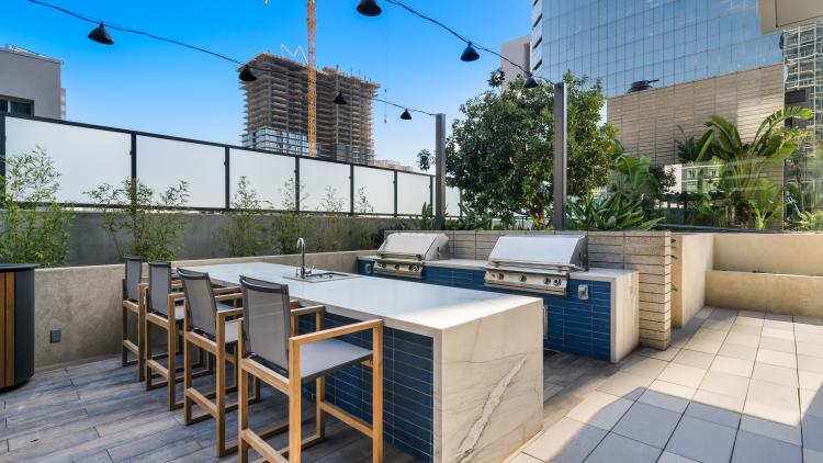 Outdoor island with stools facing two built-in grills