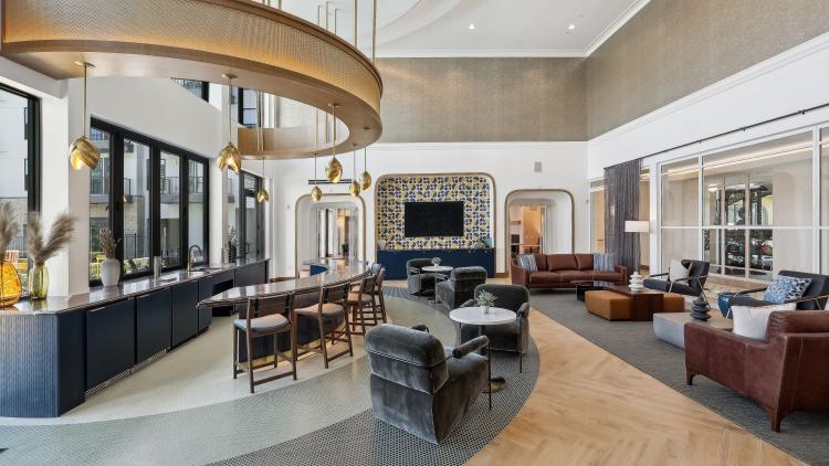 Curved bar with stools and lounge chairs around