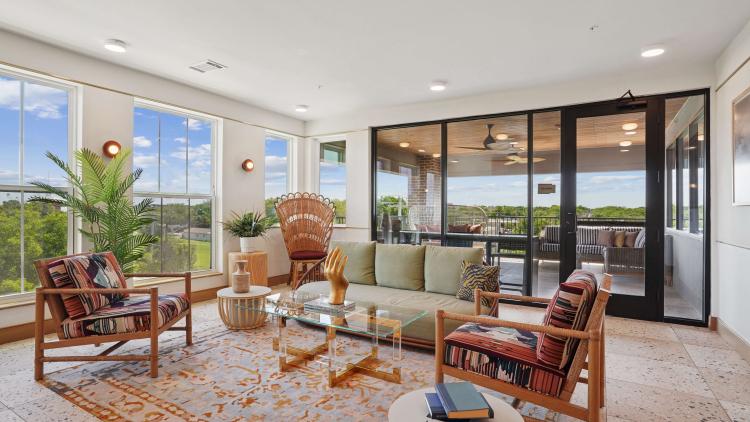 Casual seats and cafe tables in a restaurant space with a wall of windows